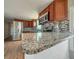 Well-appointed kitchen featuring granite countertops, wood cabinets, and stainless steel appliances at 5141 Oakland Hills Ave, Sarasota, FL 34234