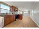 Well-lit kitchen featuring stainless steel appliances, tile backsplash, and wood-look flooring at 5141 Oakland Hills Ave, Sarasota, FL 34234