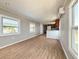 Bright living room with wood-look floors connecting to the kitchen at 5141 Oakland Hills Ave, Sarasota, FL 34234