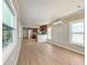 Spacious living room with wood-look floors leading into the kitchen at 5141 Oakland Hills Ave, Sarasota, FL 34234