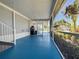 Covered patio features screened windows, stairs, and tropical views at 5141 Oakland Hills Ave, Sarasota, FL 34234