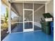 Screened-in patio with blue floor is a transitional space from the interior to the outdoors at 5141 Oakland Hills Ave, Sarasota, FL 34234