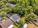An aerial view displays the home's backyard with screened lanai and the surrounding green landscape at 7511 Savannah Ln, Tampa, FL 33637