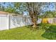 A well-maintained lawn is enclosed by a white fence in this spacious backyard at 7511 Savannah Ln, Tampa, FL 33637