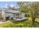 A screened patio offers outdoor living space in this home's backyard with a grassy lawn at 7511 Savannah Ln, Tampa, FL 33637