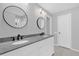 The renovated bathroom showcases double sinks, modern fixtures, and a neutral color palette at 7511 Savannah Ln, Tampa, FL 33637