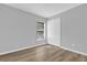 Minimalist bedroom with a window, closet, and light wood-look floors, painted a neutral gray at 7511 Savannah Ln, Tampa, FL 33637