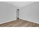 Spare bedroom with light, wood-look floors, neutral paint, and an open closet area at 7511 Savannah Ln, Tampa, FL 33637