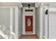 Inviting close-up of a red front door with a decorative glass insert and brick entryway at 7511 Savannah Ln, Tampa, FL 33637