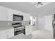 Clean, well-lit kitchen boasts modern appliances, white cabinetry, and a functional layout at 7511 Savannah Ln, Tampa, FL 33637