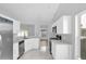 Fully renovated kitchen features stainless appliances, white cabinets, and sleek countertops at 7511 Savannah Ln, Tampa, FL 33637