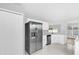Updated kitchen with stainless steel appliances, white cabinetry, and a bright, fresh aesthetic at 7511 Savannah Ln, Tampa, FL 33637
