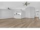 Open-concept living area with abundant space, wood-look flooring, and modern ceiling fans at 7511 Savannah Ln, Tampa, FL 33637