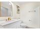 A clean, modern bathroom with gold fixtures and a unique mirror design at 203 Driftwood W Dr, Palm Harbor, FL 34683