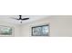 A large window in this bedroom overlooks the exterior of the house at 203 Driftwood W Dr, Palm Harbor, FL 34683