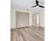 Bedroom featuring new wood flooring, neutral paint, and an open closet at 203 Driftwood W Dr, Palm Harbor, FL 34683