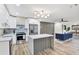 Bright open-concept kitchen with marble island and stainless appliances, flowing into the stylish living area at 203 Driftwood W Dr, Palm Harbor, FL 34683