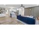 Open-concept living area with modern kitchen, stylish furniture, and wood-look flooring for a contemporary feel at 203 Driftwood W Dr, Palm Harbor, FL 34683