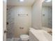 Bright bathroom featuring a marble-tiled shower and a modern white vanity with a silver faucet at 3944 11Th S Ave, St Petersburg, FL 33711
