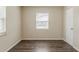 Neutral bedroom featuring gray tone flooring, a door, and a large window at 3944 11Th S Ave, St Petersburg, FL 33711