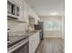 Modern kitchen featuring stainless steel appliances, granite countertops, and sleek white cabinetry at 3944 11Th S Ave, St Petersburg, FL 33711