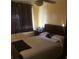 Comfortable bedroom features a queen bed, bedside table, and ceiling fan at 6718 Runningwoods Dr, Tampa, FL 33634