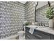 Charming powder room featuring patterned wallpaper, modern vanity, and stylish fixtures at 9188 Forge Breeze Loop, Wesley Chapel, FL 33545