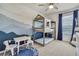 Charming bedroom featuring a unique bunk bed, a playful mural and a cozy, educational rug at 9188 Forge Breeze Loop, Wesley Chapel, FL 33545