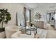 Sitting area showing mirror, storage, window, and two chairs with glass table at 9188 Forge Breeze Loop, Wesley Chapel, FL 33545
