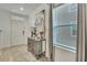 Elegant foyer with a mirrored cabinet, decorative lamps, and natural light at 9188 Forge Breeze Loop, Wesley Chapel, FL 33545