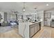 Bright, open-concept kitchen with a center island that seamlessly flows into the living area at 9188 Forge Breeze Loop, Wesley Chapel, FL 33545