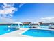 Stunning lagoon view featuring lounge areas and seating on floating platforms, with clear blue skies at 9188 Forge Breeze Loop, Wesley Chapel, FL 33545