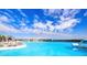 Beautiful lagoon view with seating area and backdrop of community homes under a bright sky at 9188 Forge Breeze Loop, Wesley Chapel, FL 33545