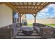 Relaxing patio area featuring a fire pit and comfortable outdoor couches at 9188 Forge Breeze Loop, Wesley Chapel, FL 33545