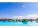 Floating water park with inflatable slides and climbing structures surrounded by blue water and sky at 9188 Forge Breeze Loop, Wesley Chapel, FL 33545