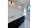 Modern bathroom featuring double sinks, quartz countertops, and sleek black cabinetry at 2309 S Ardson Pl # 1, Tampa, FL 33629