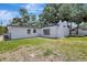 Backyard featuring white exterior and green lawn at 4928 Stolls Ave, Tampa, FL 33615