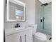 Updated bathroom with modern vanity, backlit mirror, and a stylish glass-enclosed shower at 4928 Stolls Ave, Tampa, FL 33615