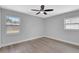 Well-lit bedroom with neutral walls, new flooring, and a ceiling fan offering a calm feel at 4928 Stolls Ave, Tampa, FL 33615