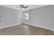 Bedroom with new flooring, neutral walls, a ceiling fan, and a window bringing in light at 4928 Stolls Ave, Tampa, FL 33615