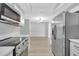 Contemporary kitchen with stainless steel appliances and an open view into the living space at 4928 Stolls Ave, Tampa, FL 33615