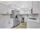 Modern kitchen featuring stainless steel appliances, quartz countertops, and white cabinets at 4928 Stolls Ave, Tampa, FL 33615