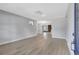 Spacious living room featuring sleek flooring, fresh paint and a fireplace in the distance at 4928 Stolls Ave, Tampa, FL 33615