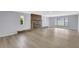 Spacious living room featuring a fireplace, neutral paint, and new flooring, filled with natural light at 4928 Stolls Ave, Tampa, FL 33615