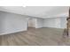 Open-concept living room with fresh paint, new flooring, and easy access to the entryway at 4928 Stolls Ave, Tampa, FL 33615