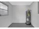 Utility room featuring a newer hot water tank at 4928 Stolls Ave, Tampa, FL 33615