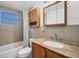 Bathroom with tiled shower, granite counters and wooden cabinets at 6940 82Nd N Ave, Pinellas Park, FL 33781