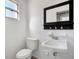 Compact bathroom features a vanity sink, toilet and medicine cabinet at 6940 82Nd N Ave, Pinellas Park, FL 33781