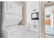 Laundry room with washer/dryer leading to an adjacent bathroom at 6940 82Nd N Ave, Pinellas Park, FL 33781