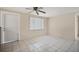 Bright living room with tiled floors, a ceiling fan, and a door for easy access at 6940 82Nd N Ave, Pinellas Park, FL 33781